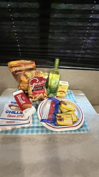 Welcome snack basket with chips, cookies, wine, and treats inside an RV