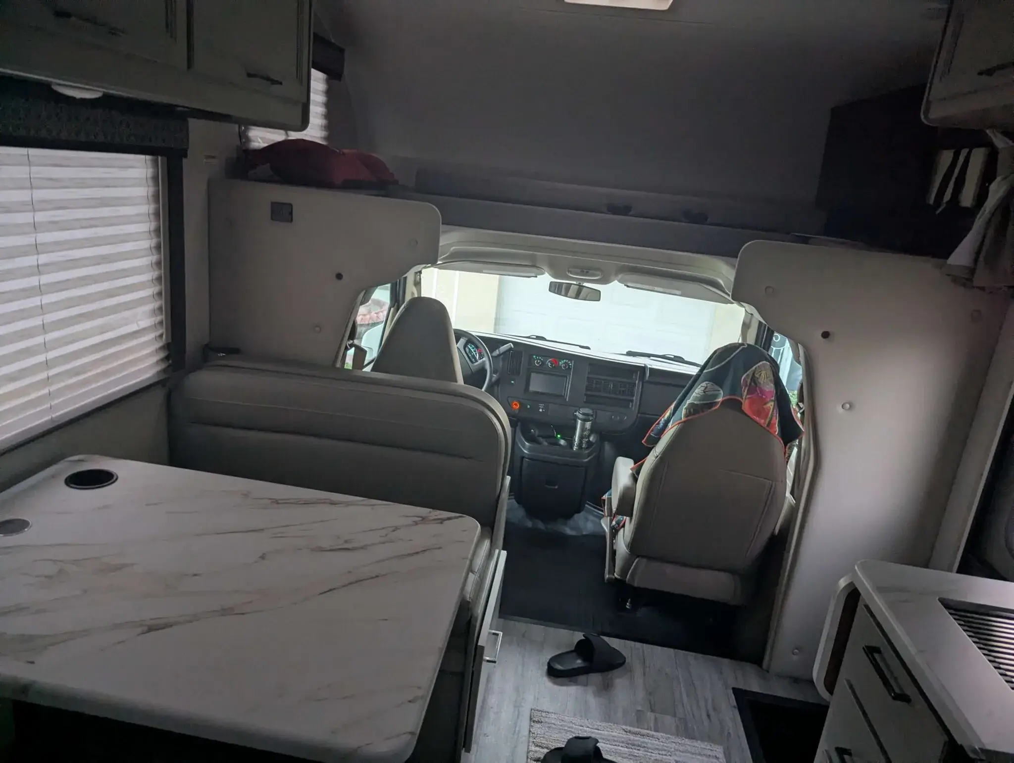 Small motorhome front seating area with dashboard and windshield